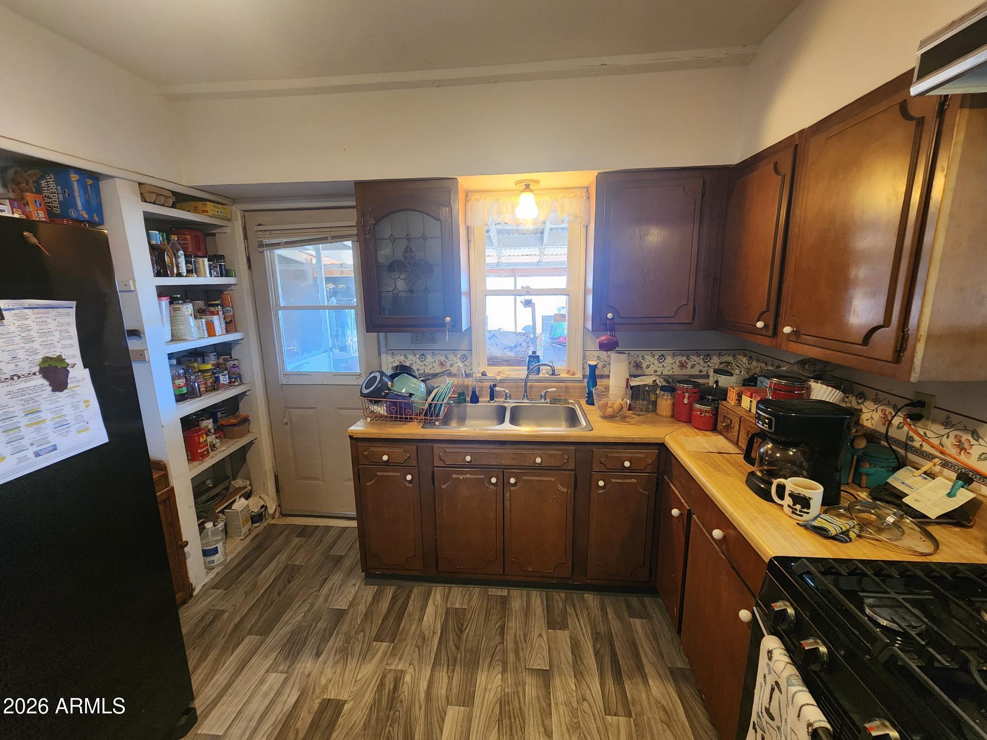 26115 Ghost Town Road Congress, AZ 85332 - Photo 10 of 64 a kitchen with stainless steel appliances granite countertop a sink dishwasher stove and cabinets