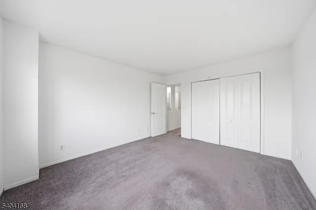 a view of an empty room and closet area