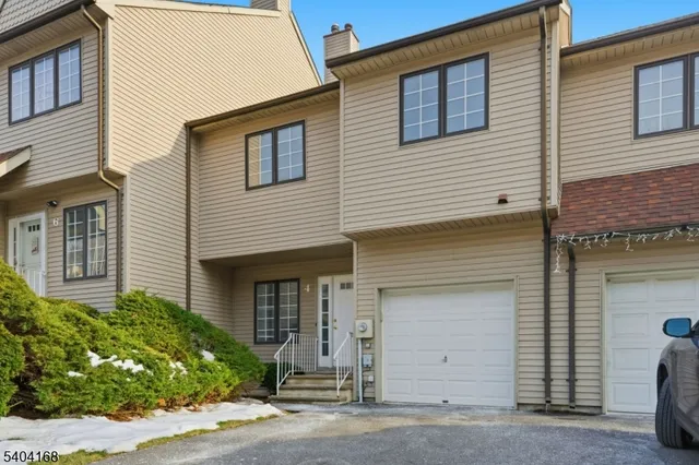 a view of a house with a small space and parking space