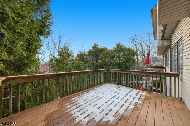 a balcony with wooden floor and fence