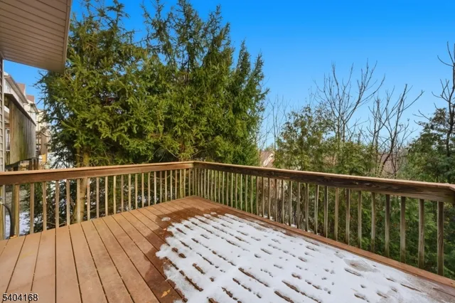 a balcony with wooden floor and fence