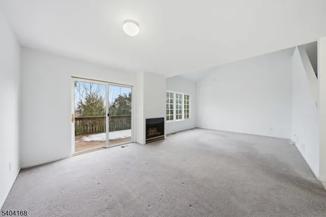 an empty room with floor to ceiling window