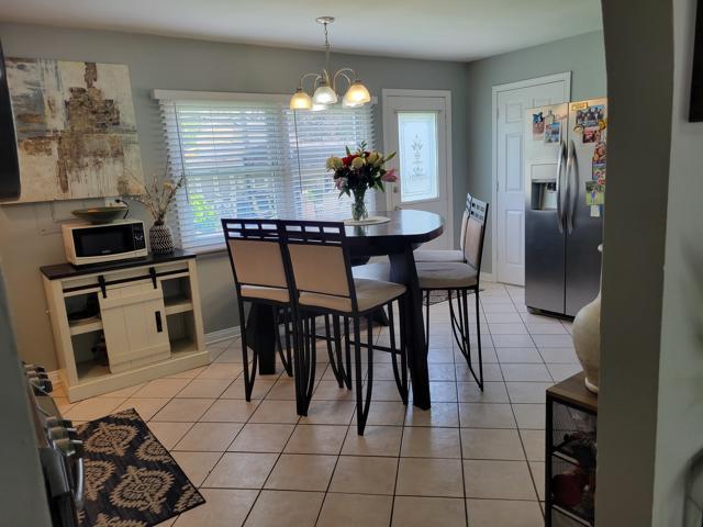 225 Hemlock Avenue Romeoville, IL 60446 - Photo 14 of 32 a dining area with a table chairs and a kitchen view