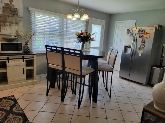 225 Hemlock Avenue Romeoville, IL 60446 - Photo 15 of 32 a dining room filled chandelier and kitchen view