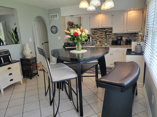 225 Hemlock Avenue Romeoville, IL 60446 - Photo 17 of 32 a dining room filled chandelier and kitchen view