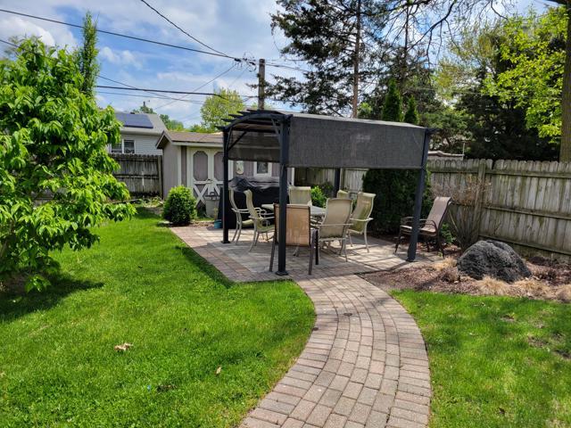 225 Hemlock Avenue Romeoville, IL 60446 - Photo 28 of 32 a view of a patio with table and chairs potted plants and large tree