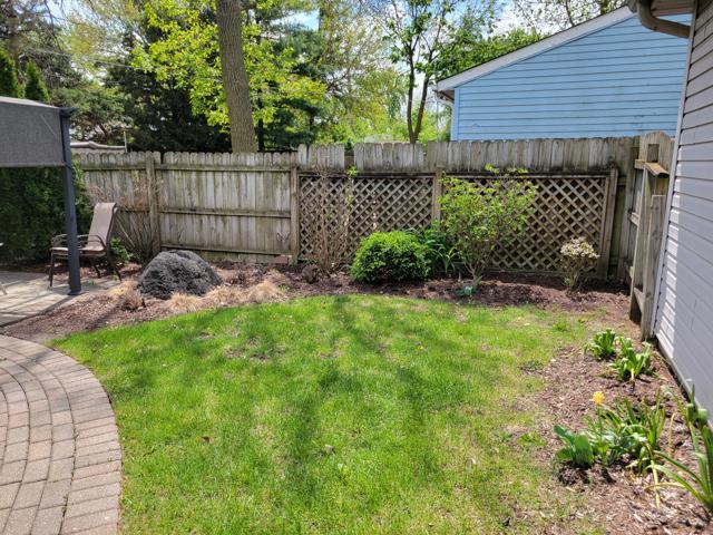 225 Hemlock Avenue Romeoville, IL 60446 - Photo 30 of 32 a view of a backyard with plants and wooden fence
