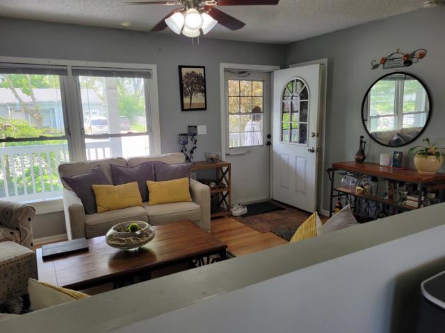 225 Hemlock Avenue Romeoville, IL 60446 - Photo 6 of 32 a living room with furniture a fireplace and a large window