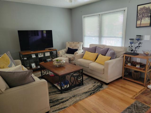 225 Hemlock Avenue Romeoville, IL 60446 - Photo 7 of 32 a living room with furniture a flat screen tv and a window