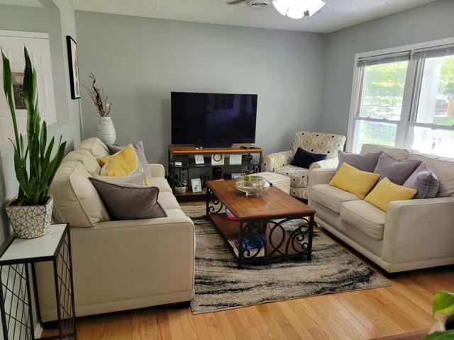 225 Hemlock Avenue Romeoville, IL 60446 - Photo 10 of 32 a living room with furniture and a flat screen tv