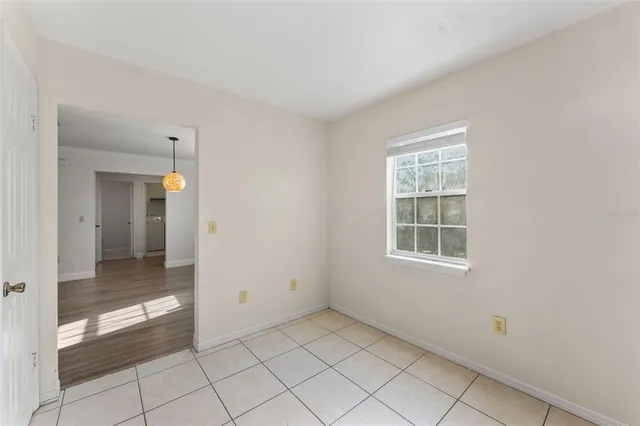 an empty room with entrance and windows