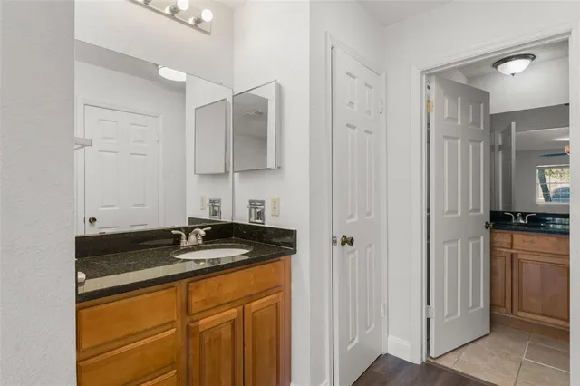 a kitchen with stainless steel appliances granite countertop a sink and a refrigerator