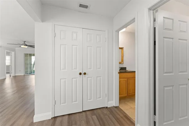 a view of a hallway with wooden floor