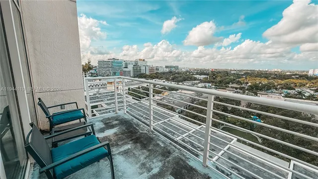 a view of a balcony with wooden floor and city view