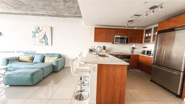 a living room with a couch and a refrigerator