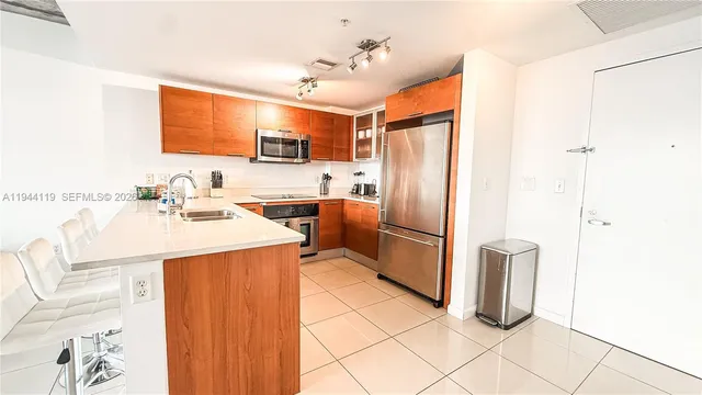 a kitchen with stainless steel appliances a refrigerator and a sink