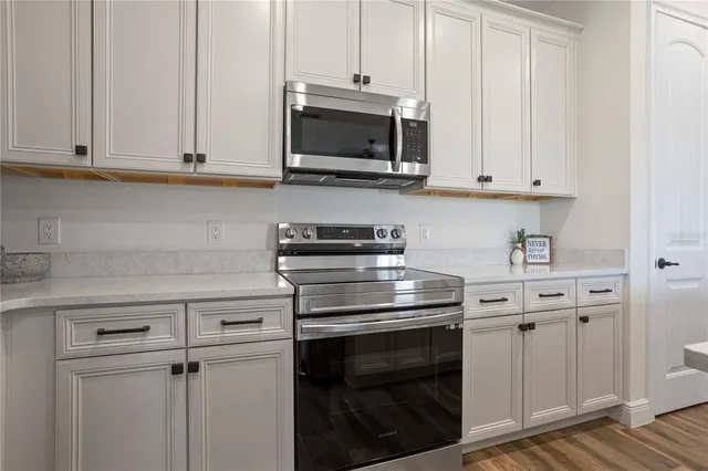 a kitchen with kitchen island a appliances a table and chairs