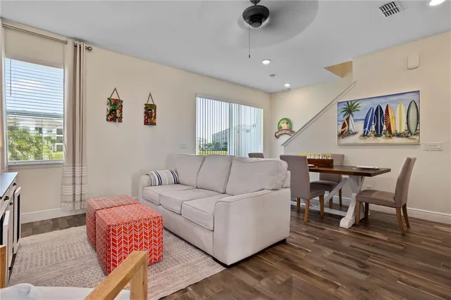 a view of a dining room with furniture wooden floor and a potted plant