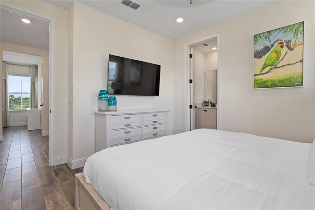 a bedroom with a bed and a tv