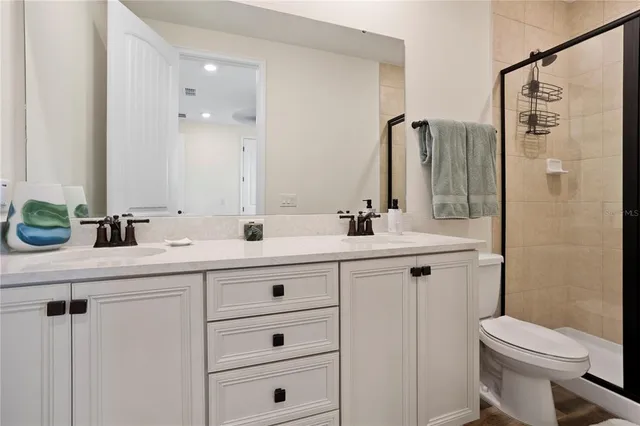 a bedroom with a bed and a flat tv screen on wall