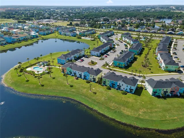 an aerial view of a house with a garden and lake view