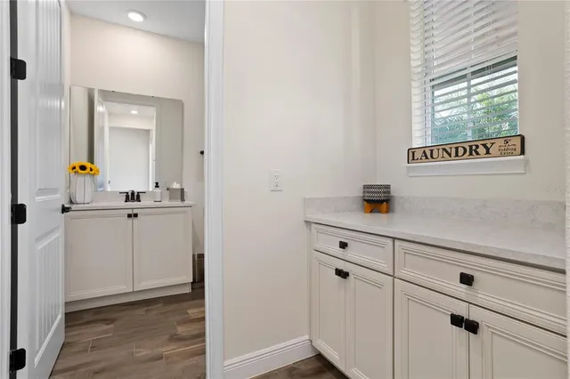 a kitchen with stainless steel appliances granite countertop a sink and dishwasher a refrigerator with white cabinets