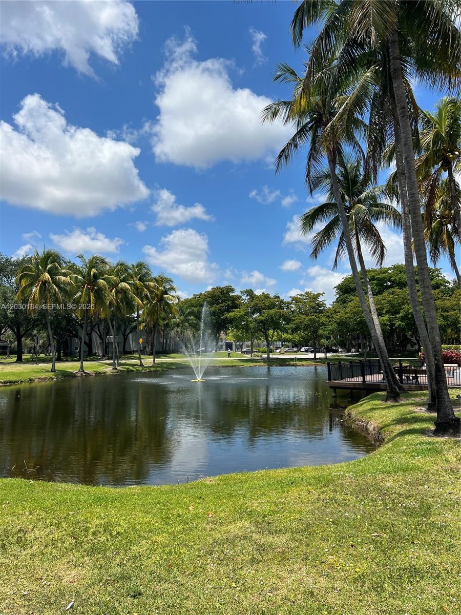 951 Lyons Road, Unit 6104 Coconut Creek, FL 33063 - Photo 17 of 18 a view of a lake with a house