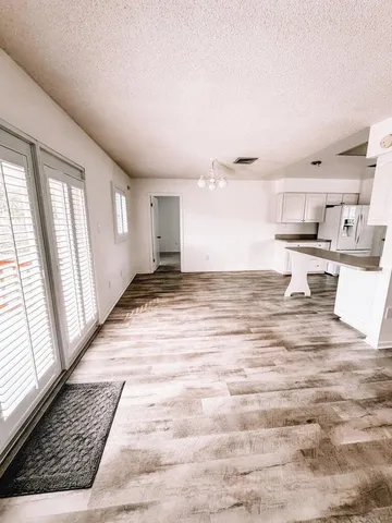 a living room with kitchen island furniture and a fireplace