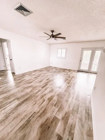a view of an empty room and a window