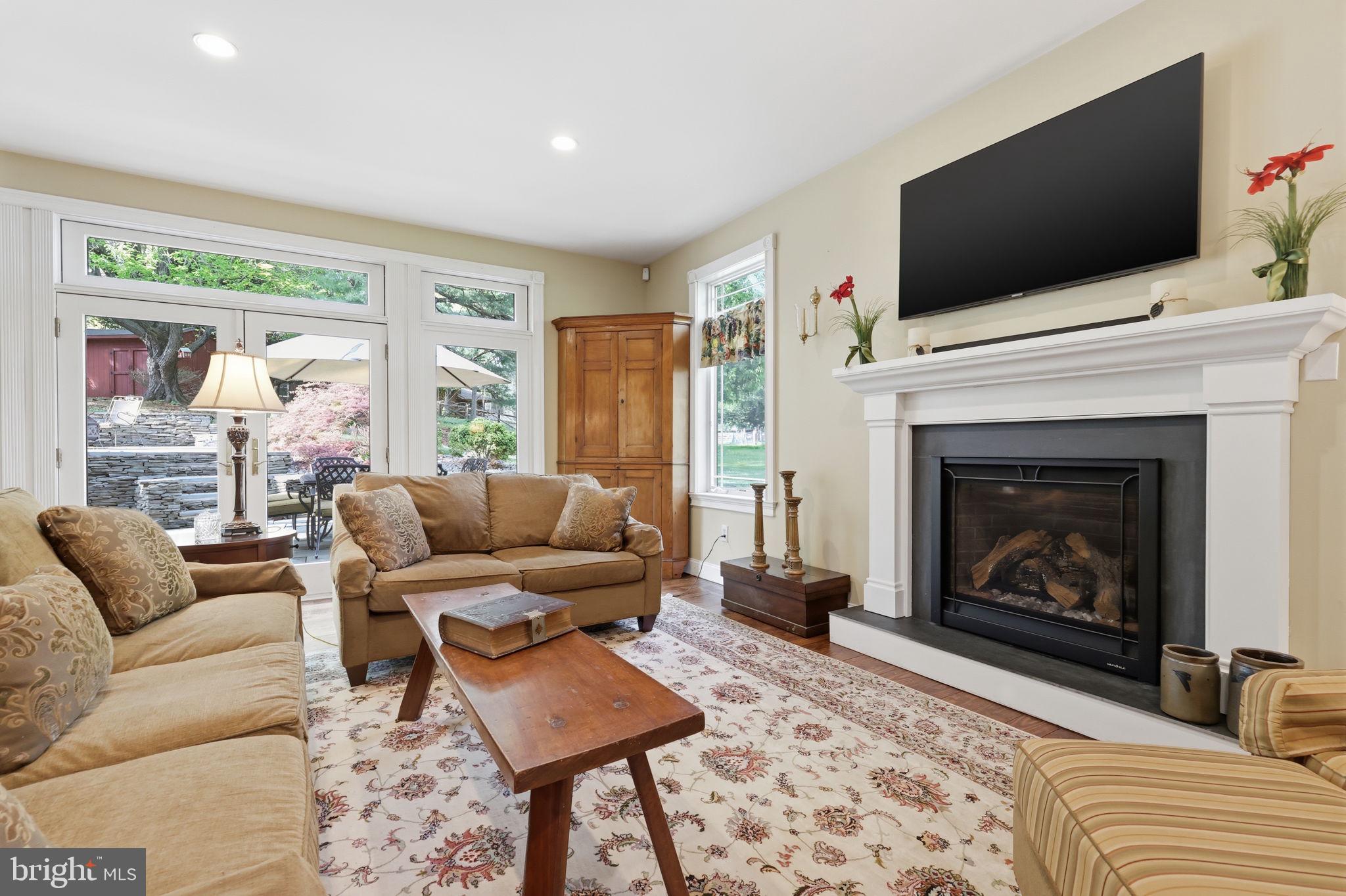 43 Twining Ford Road Richboro, PA 18954 - Photo 26 of 57 a living room with furniture a flat screen tv and a fireplace