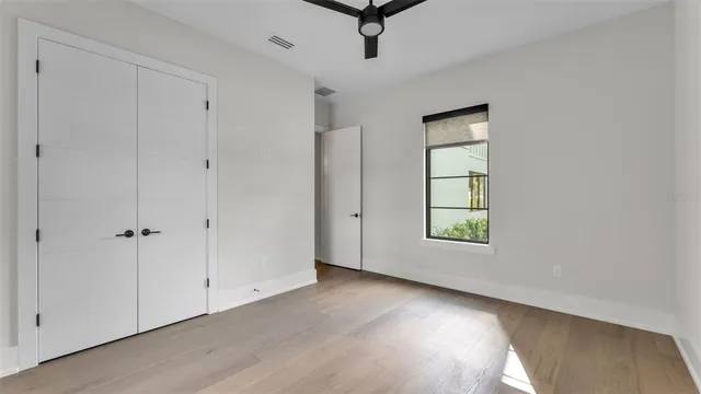 a bathroom with a granite countertop sink a toilet a shower and a mirror