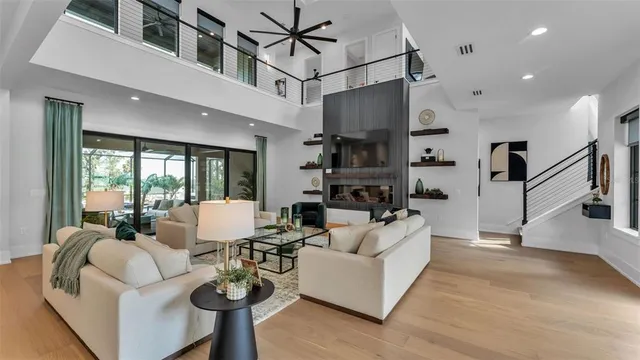 a living room with furniture and a chandelier