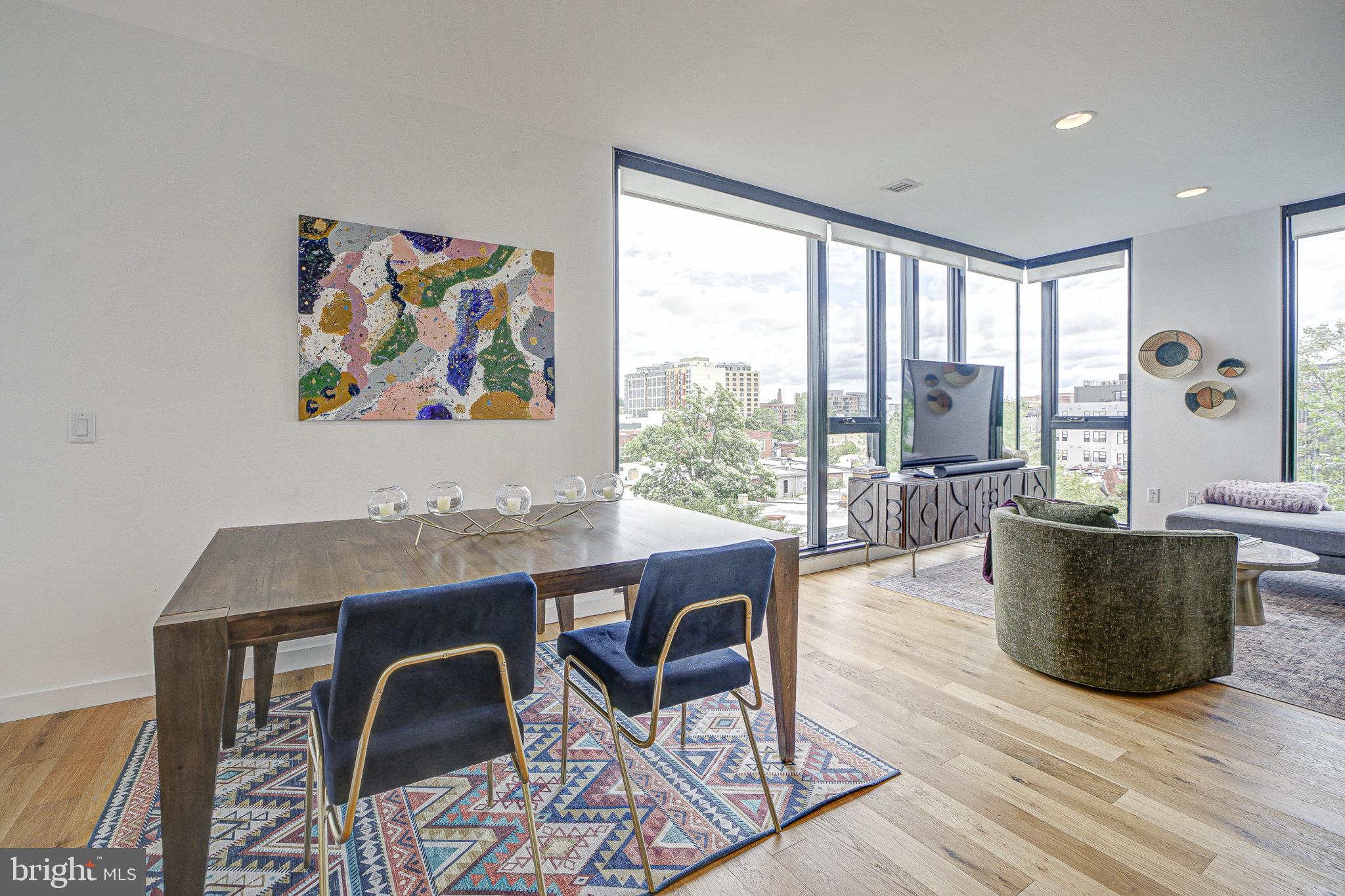 57 N Street Northwest, Unit 525 Washington, DC 20001 - Photo 3 of 40 a view of a dining room with furniture wooden floor and a large window