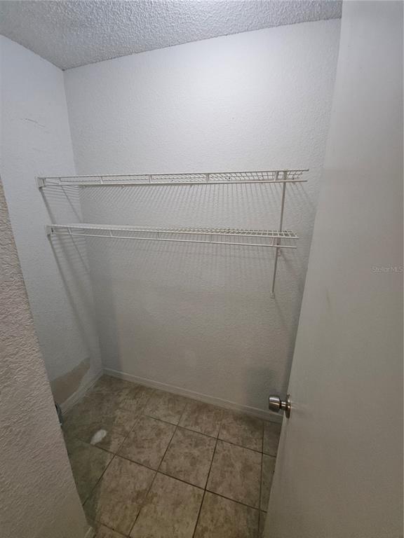 5160 Conroy Road, Unit 1437 Orlando, FL 32811 - Photo 18 of 36 a view of a room with racks on the wall