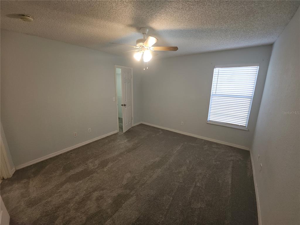 5160 Conroy Road, Unit 1437 Orlando, FL 32811 - Photo 19 of 36 an empty room with a fan and a window