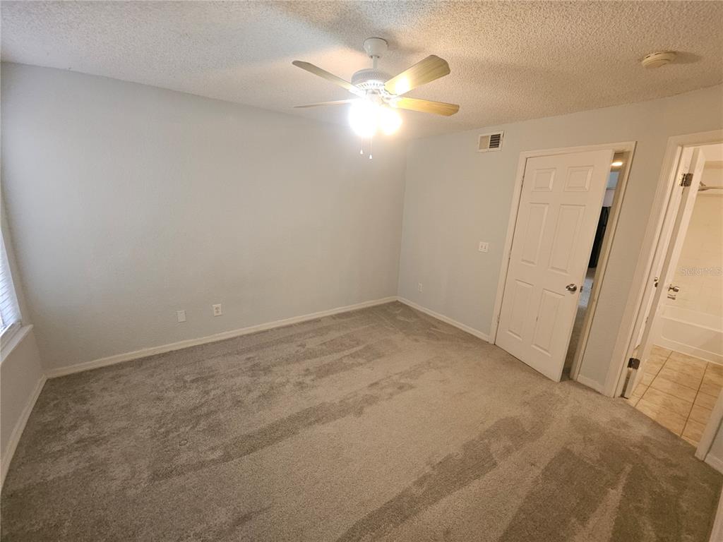 5160 Conroy Road, Unit 1437 Orlando, FL 32811 - Photo 21 of 36 en empty room with windows and entrance