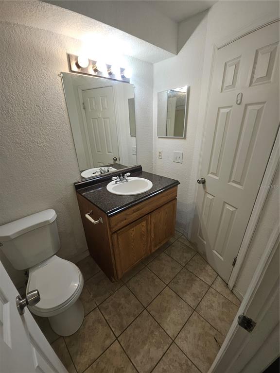 5160 Conroy Road, Unit 1437 Orlando, FL 32811 - Photo 23 of 36 a bathroom with a sink a toilet a mirror and shower