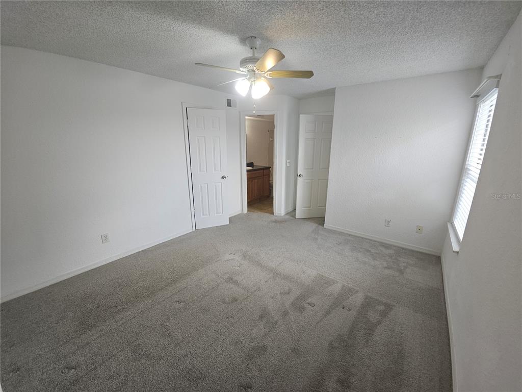 5160 Conroy Road, Unit 1437 Orlando, FL 32811 - Photo 28 of 36 a view of an empty room with a chandelier fan
