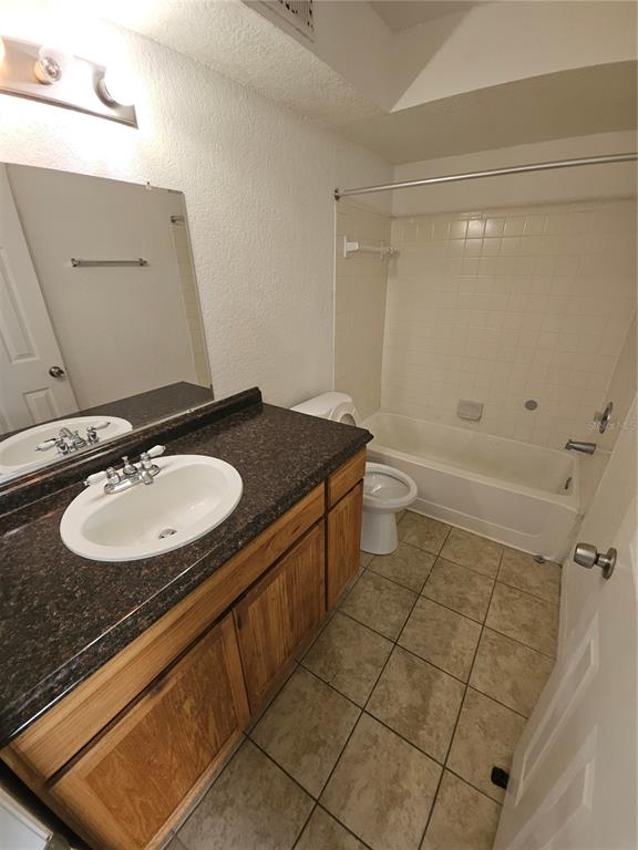 5160 Conroy Road, Unit 1437 Orlando, FL 32811 - Photo 31 of 36 a bathroom with a sink a toilet and shower