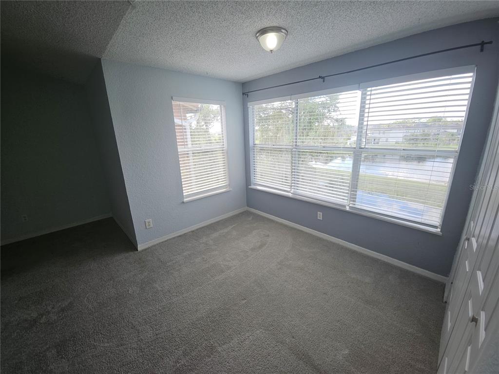 5160 Conroy Road, Unit 1437 Orlando, FL 32811 - Photo 9 of 36 an empty room with windows