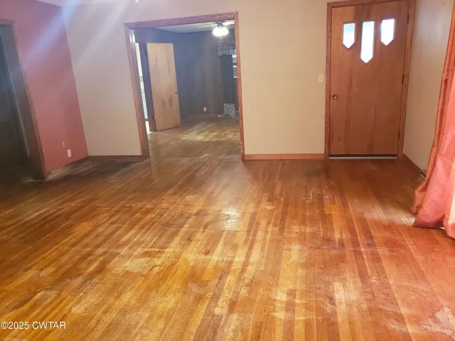 a view of a room with wooden floor