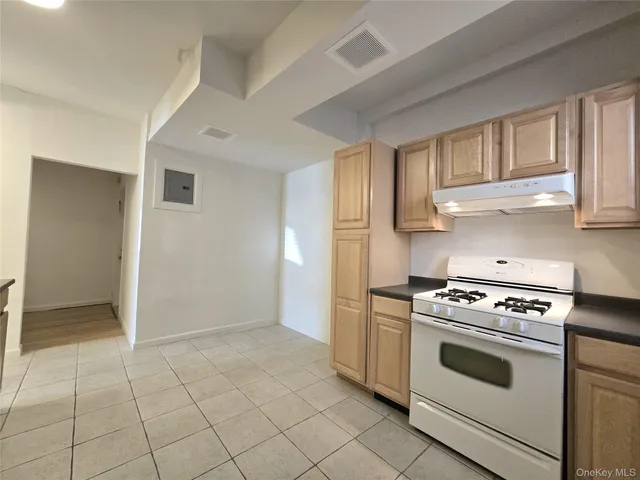 a kitchen with white cabinets and appliances