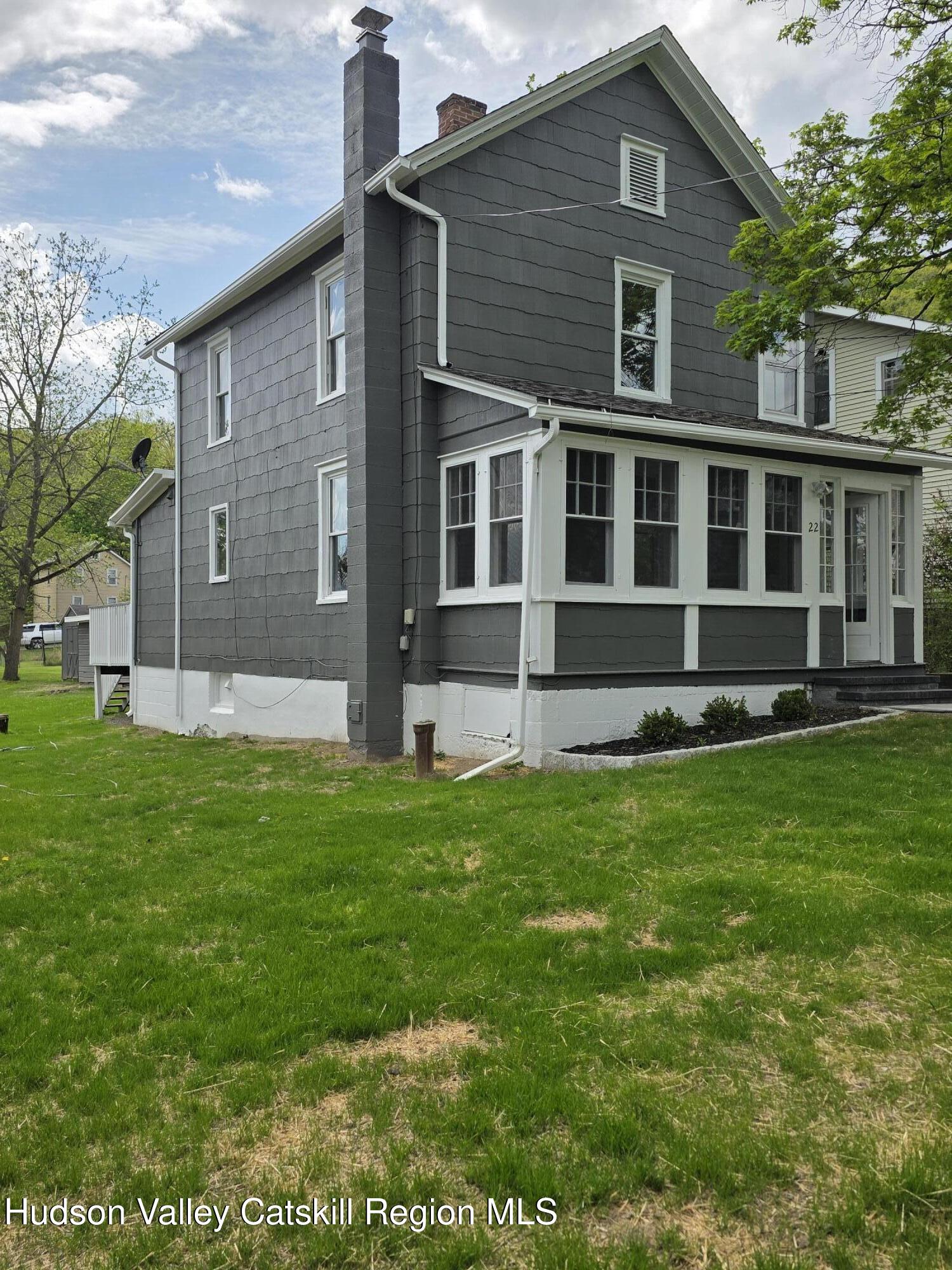 22 Maple Street Catskill, NY 12414 - Photo 1 of 16 a front view of a house with a yard