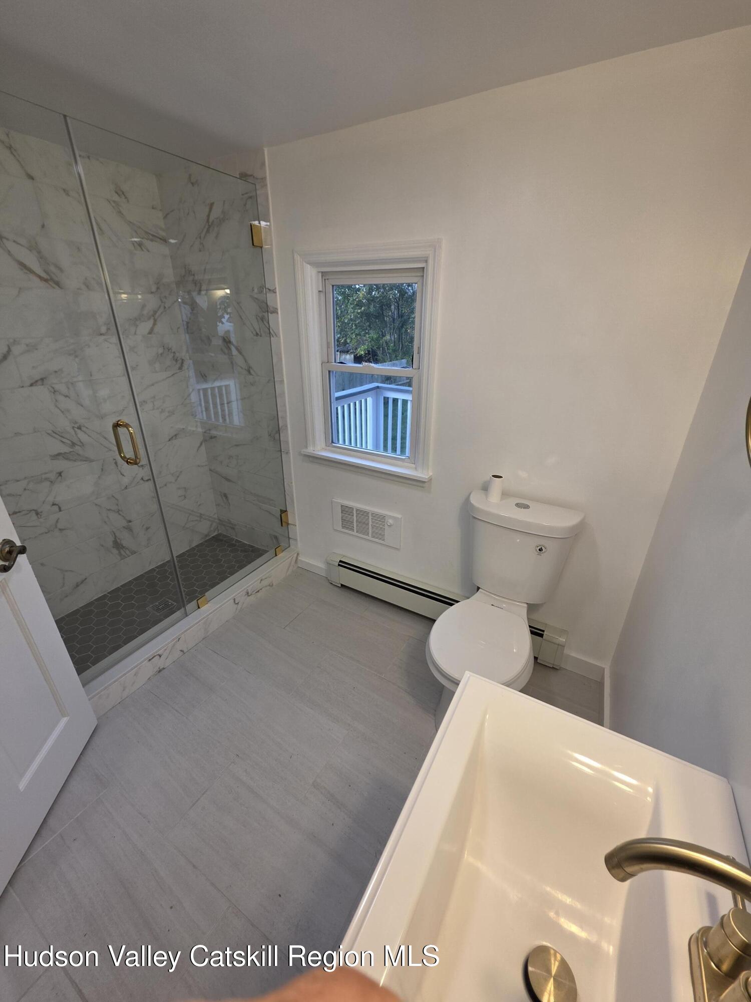 22 Maple Street Catskill, NY 12414 - Photo 9 of 16 a bathroom with a bathtub and a shower