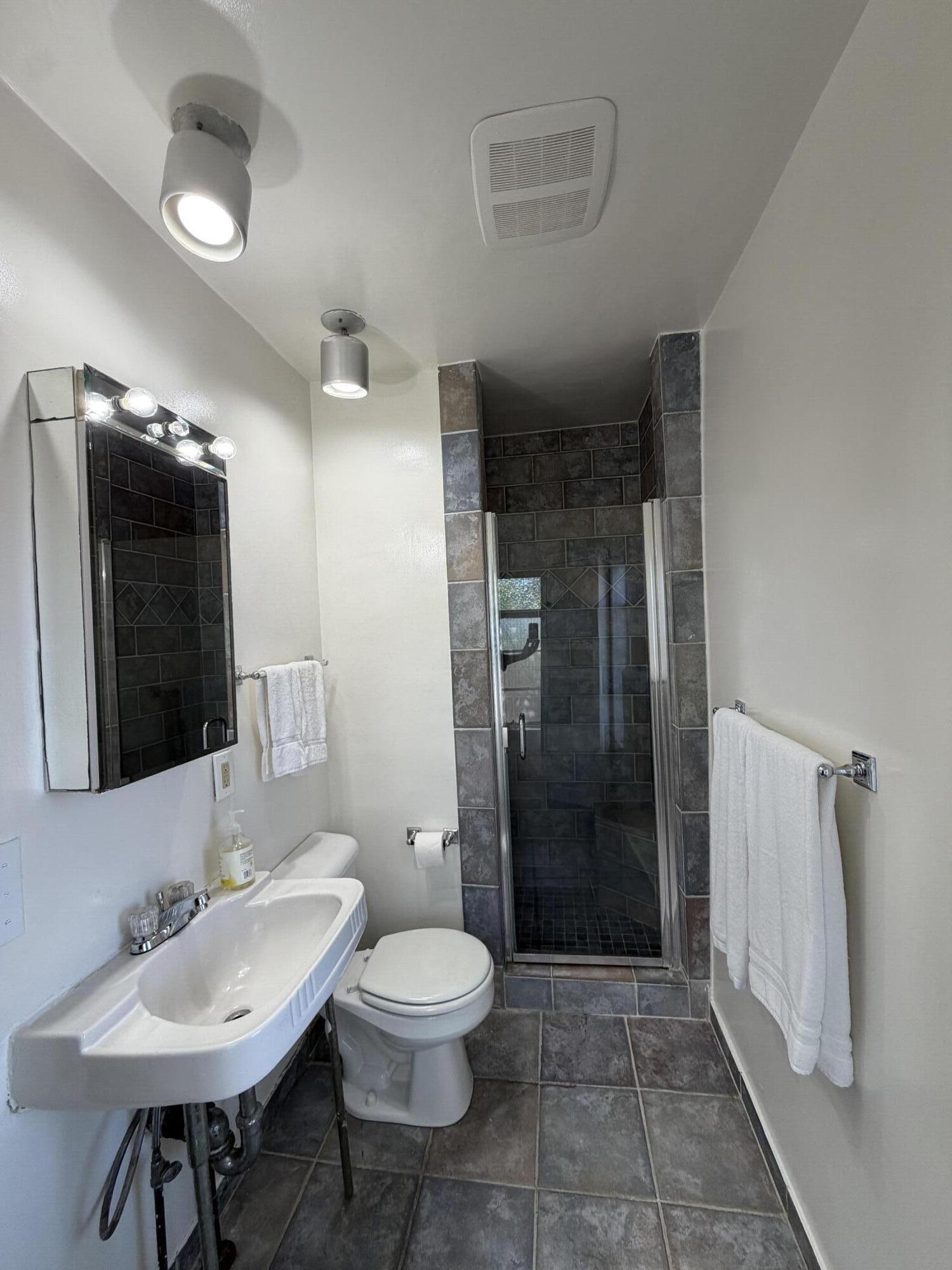 316 Oceano Avenue, Unit B Santa Barbara, CA 93109 - Photo 12 of 17 a bathroom with a toilet a sink and mirror