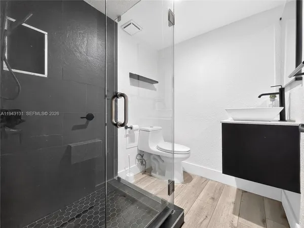 a spacious bathroom with a toilet and a shower