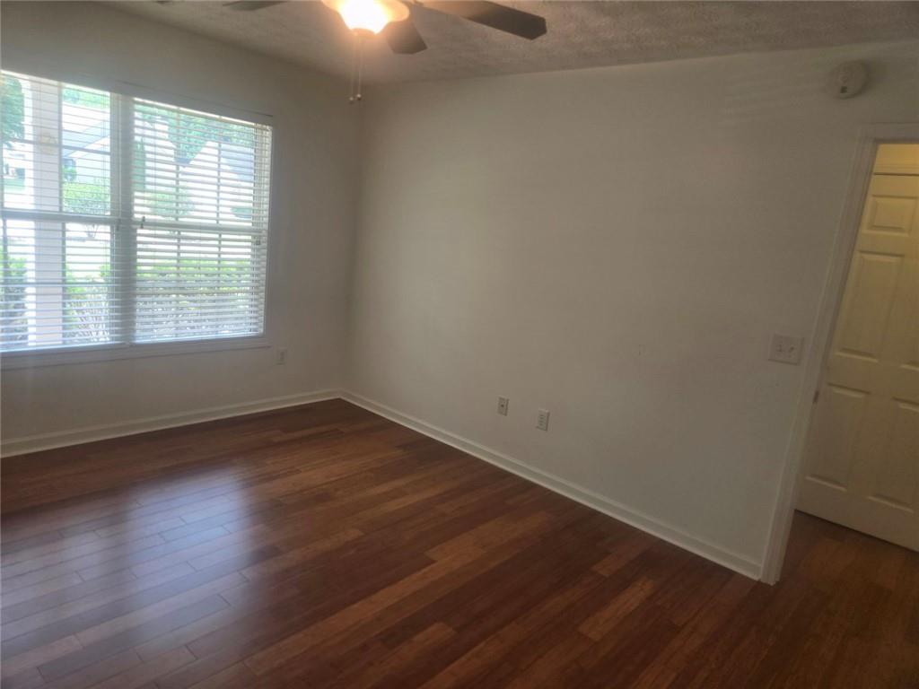 22 Windcrest Keep Covington, GA 30016 - Photo 25 of 32 an empty room with wooden floor and windows