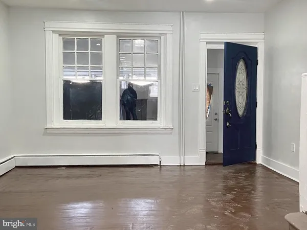 a view of a living room with furniture and a fireplace
