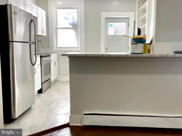 a white refrigerator freezer and a stove sitting inside of a kitchen