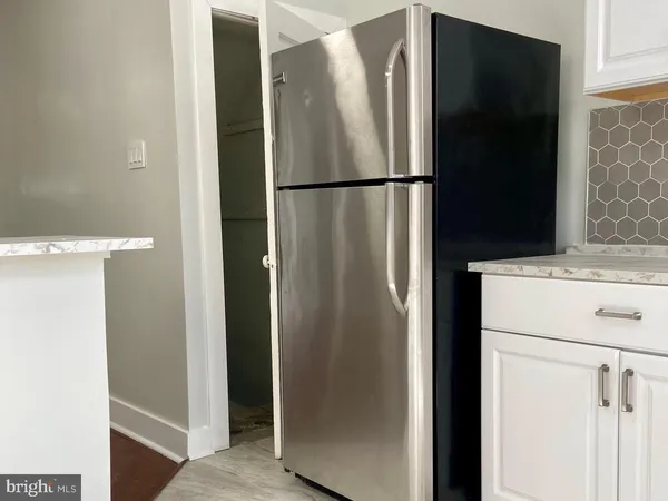 a stove top oven sitting inside of a kitchen